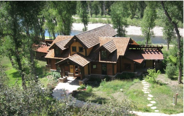 Residential roof replacement on a mountain log home featuring multi-level brown shingles.