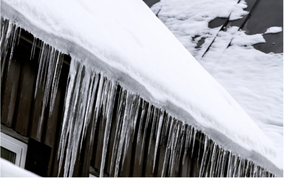 Severe roof snow accumulation and ice dams requiring professional roof shoveling.